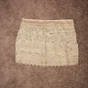 Short crocheted, lacey skirt. Gold / tan
